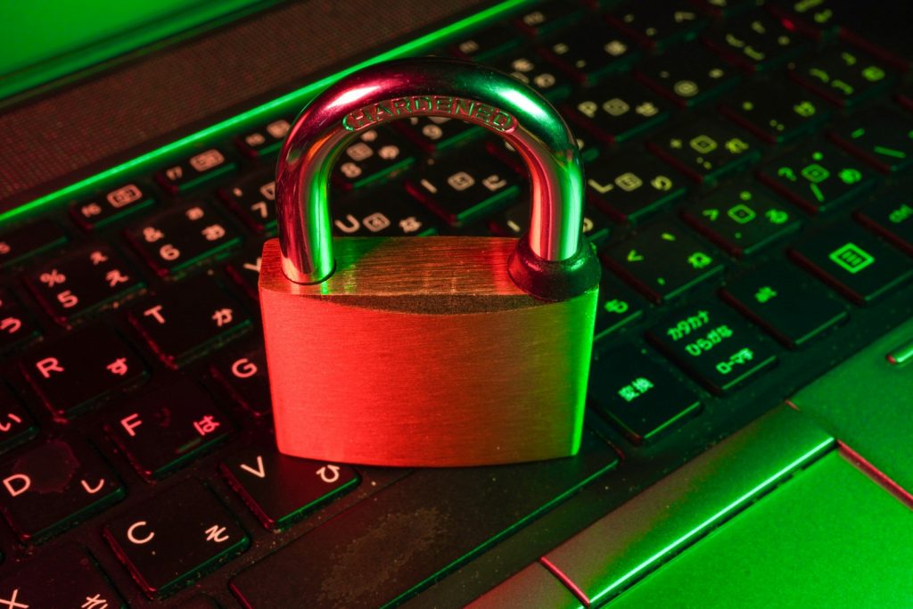 Red padlock on a black computer keyboard, illustrating hacked WordPress site recovery