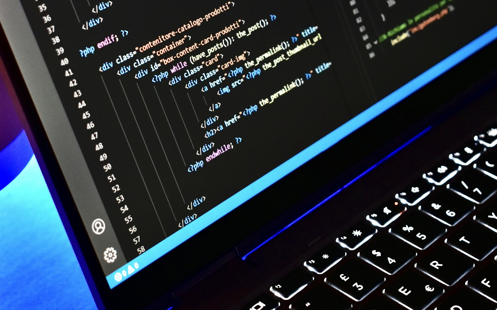 PHP code on a laptop screen in a dark workspace, illustrating a PHP version compatibility fix for WordPress
